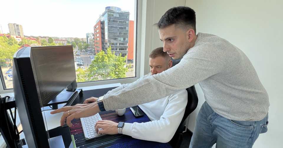 A photo of Rytis & Filip looking at the new designs